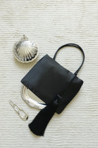 Minimalist Black Nylon Top Handle Bag with Statement Silk Tassel Accent
