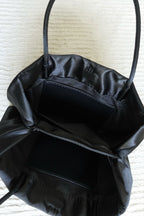 Minimalist Black Nylon Top Handle Bag with Statement Silk Tassel Accent